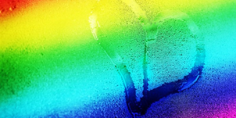 Hand drawing heart on the wet window glass, Gay 8 stripe flag gradient, gay love concept