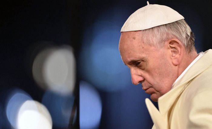 Pope Francis leads the celebration of the Way of the Cross on Good Friday on March 29, 2013 at the Colosseum in Rome. Pope Francis presided over his first Good Friday which will culminate in a torch-lit procession at Rome's Colosseum and prayers for peace in a Middle East "torn apart by injustice and conflicts". AFP PHOTO / GABRIEL BOUYS