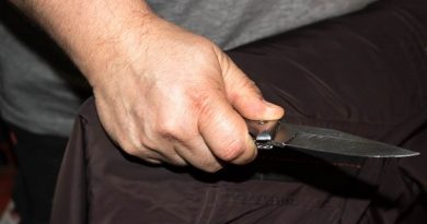 Closeup of a young man hand, holding a knife, about to attack,