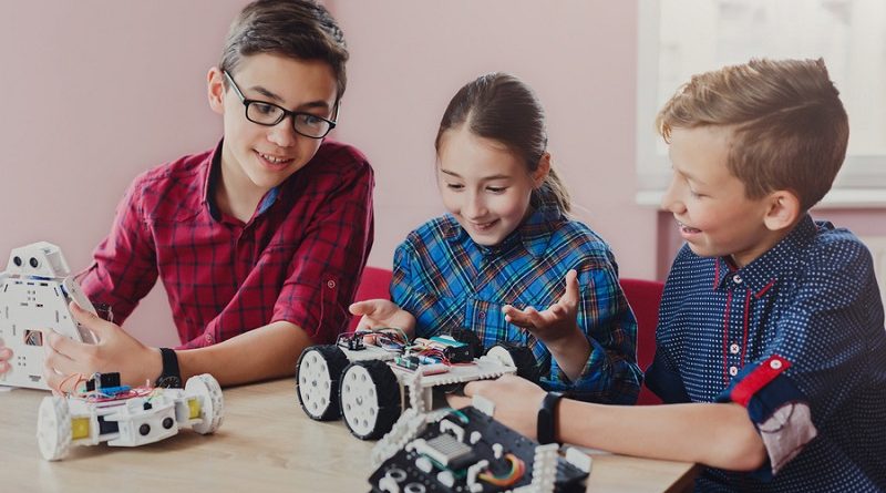 Children creating robots at school, stem education, copy space. Early development, diy, innovation, modern technology concept