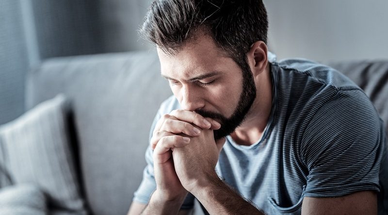 Serious cheerless man looking down