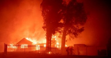 (FILES) In this file photo taken on October 31, 2019 a firefighter works the scene as wind-whipped flames and embers light multiple homes on fire during the Hillside fire in the North Park neighborhood of San Bernardino, California. - US President Donald Trump threatened once again on November 3, 2019 to withhold federal aid from California after its Democratic governor criticized his environmental policies.Over the past two weeks, fires have ravaged nearly 100,000 acres (40,000 hectares) in the sprawling western state, where fighters on Sunday were battling the Maria Fire, about 60 miles northwest of Los Angeles. (Photo by Josh Edelson / AFP)