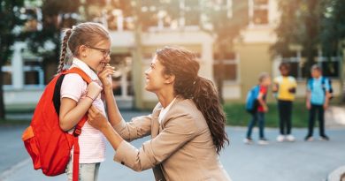 First day at school. Mother leads a little child school girl in first grade.