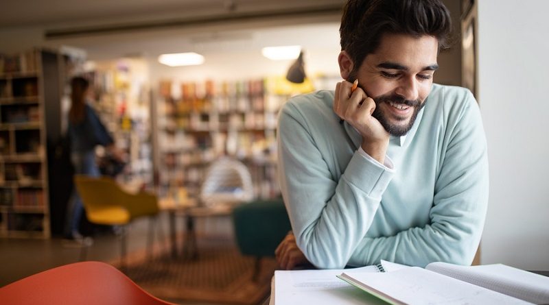 Student preparing exam and learning lessons in college library