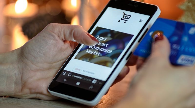 person-using-black-and-white-smartphone-and-holding-blue-230544