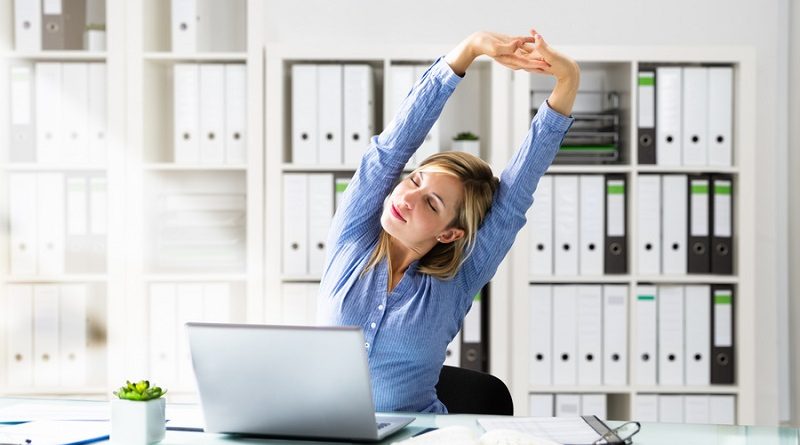 Woman Stretches At Office Desk. Stretching Exercise