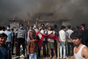 Manifestantes comemoram com bandeira do Nepal após entrar em complexo do Parlamento nepalês durante protesto contra o governo em 9 de setembro de 2025. — Foto: REUTERS/Adnan Abidi